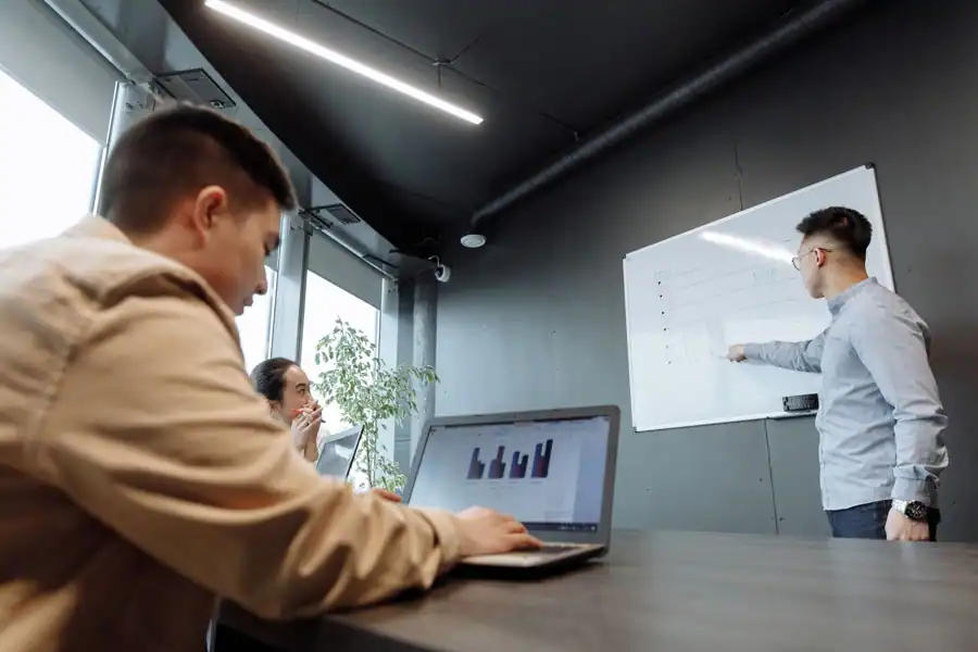Colleagues discussing strategies in a modern conference room.